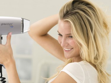 blond girl with hair dryer